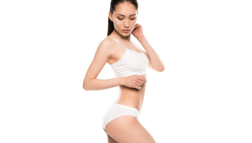 slim attractive asian woman posing in white underwear, isolated on white
